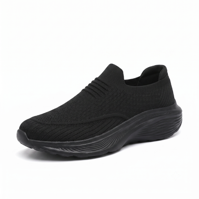 Svart slip-on komfortsko unisex med tjock stötdämpande sula och mjukt sticktyg mot vit bakgrund
