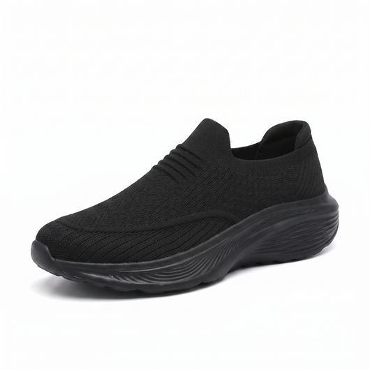 Svart slip-on komfortsko unisex med tjock stötdämpande sula och mjukt sticktyg mot vit bakgrund