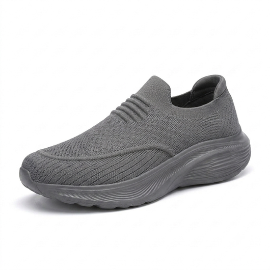 Grå slip-on komfortsko unisex med stötdämpande sula och stretchigt sticktyg mot vit bakgrund